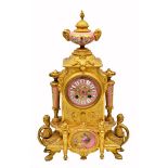 A LATE 19TH CENTURY FRENCH GILT METAL MANTLE CLOCK with pink porcelain mounts stamped P.H. Mourey to