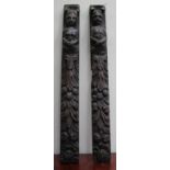 A PAIR OF ANTIQUE CARVED WOODEN ELEMENTS, each with figures above floral wreaths, 3cm in length