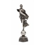 AN ANTIQUE FRENCH WHITE METAL SCULPTURE OF A FEMALE FIGURE balancing on a globe mounted on a