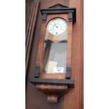 A VIENNA STYLE WALNUT AND EBONISED WALL CLOCK with white enamel dial and Roman numerals 44cm high