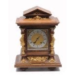 A LATE 19TH CENTURY OAK CASED MANTLE CLOCK with gilt metal mounts, the silvered dial with Roman