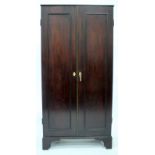 A GEORGE III MAHOGANY ESTATE CUPBOARD with twin panelled doors opening to reveal a fitted