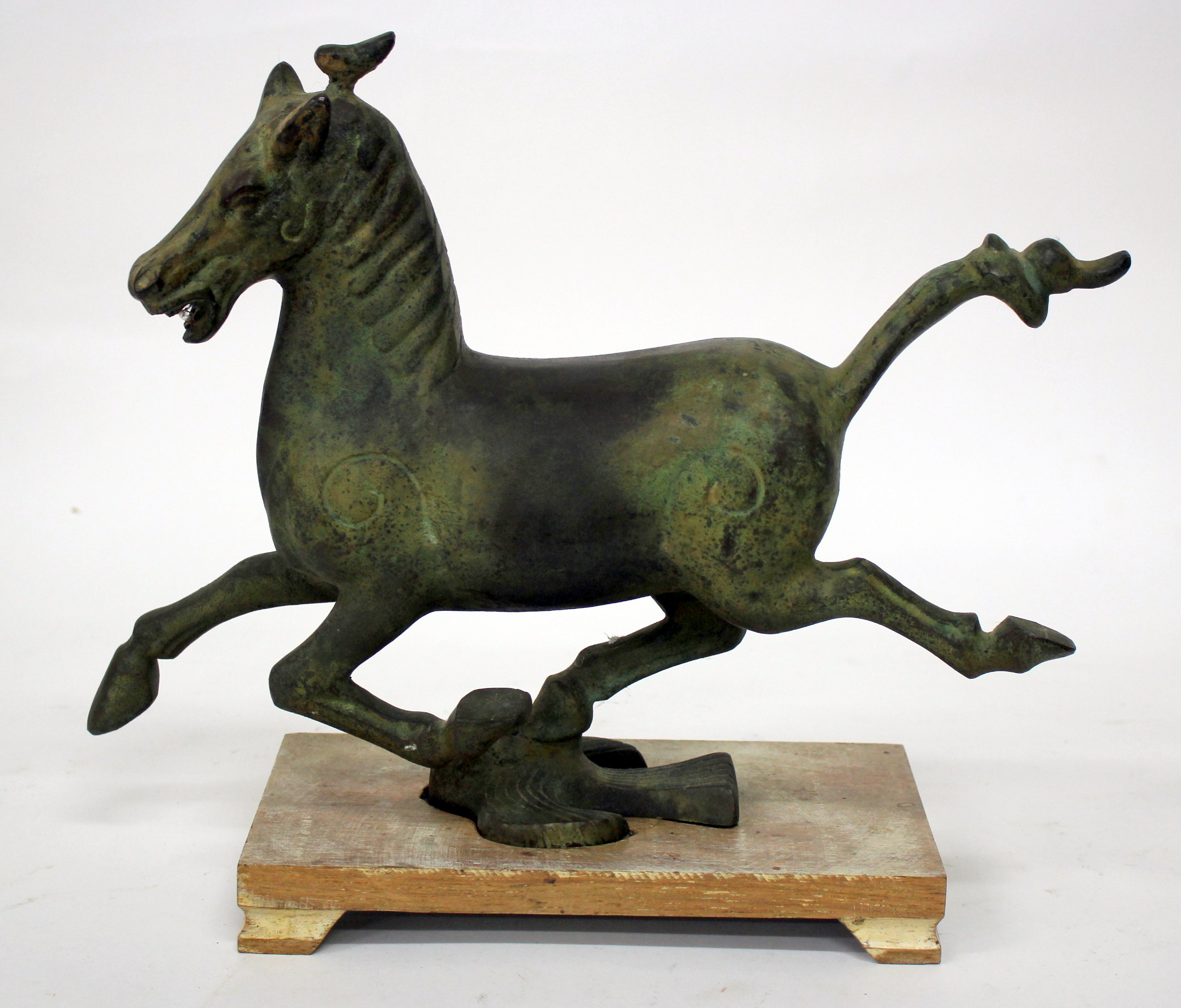 A BRONZE SCULPTURE OF A RUNNING HORSE, after the Chinese antique, 27cm high and mounted on a