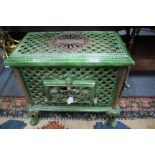 A 1920'S FRENCH GREEN ENAMELLED CHAUFFETTE WOOD BURNING STOVE by Godin and with pierced lattice work