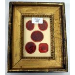 A GROUP OF FIVE WAX SEALS in a gilt frame, the frame 18.5cm wide