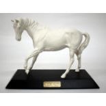 A BESWICK PORCELAIN FIGURE OF A WHITE HORSE mounted on a black painted wooden base "Spirit of