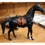 A BLACK LEATHER COVERED SCULPTURE of a horse with saddle 33cm high