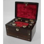 A VICTORIAN ROSEWOOD LADIES DRESSING BOX with pewter stringing and mother of pearl roundels, the