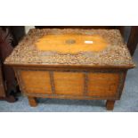 AN INDIAN HARDWOOD CARVED BOX with foliate decoration, 53.5cm wide x 33cm high