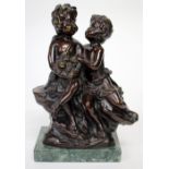 A PAIR OF BRONZE CHERUBS on a hardstone base, indistinctly signed lower right, 21cm in height