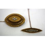 A VICTORIAN GILT NAVETTE SHAPED BROOCH inset with four seed pearls and rope twist decoration