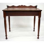 AN AMERICAN CHERRY WOOD DESK, the fall front with interior with pigeon holes standing on turned