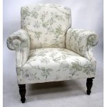 AN OLD FLORAL UPHOLSTERED ARMCHAIR with turned front legs, 86cm wide