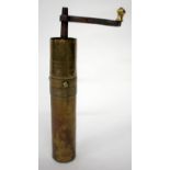 AN OLD BRASS AND IRON CYLINDRICAL COFFEE OR SPICE GRINDER with decorative banding, 26.5cm high