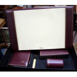 A HARROD'S BURGUNDY LEATHER DESK SET with blotter pad, letter rack, pen pot, letter opener and