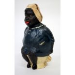 A CAST IRON NOVELTY MONEY BOX in the form of a large woman seated upon the toilet, 20cm tall