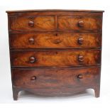A 19TH CENTURY MAHOGANY BOW FRONTED CHEST OF DRAWERS with turned knob handles and bracket feet,