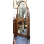 A MAHOGANY CHEVAL MIRROR, the bevelled mirror plate with arching top, 60cm wide x 166cm high