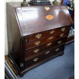 A LATE 18TH CENTURY OAK BUREAU, the fall front with shell inlay opening to reveal a serpentine