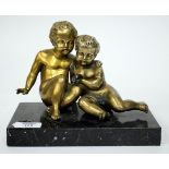 TWO GRAND TOUR GILT BRONZE CHERUBS on a square black marble base, overall 22cm wide