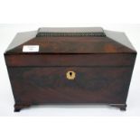 A REGENCY MAHOGANY TEA CADDY of sarcophagus form on small bracket feet, the interior with two lidded