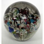 A VICTORIAN DUMP GLASS PAPERWEIGHT of domed form containing bubbles and various enamel colours