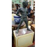 A 20TH CENTURY BRONZED RESIN SCULPTURE of a nude standing man with feet apart on a painted wooden