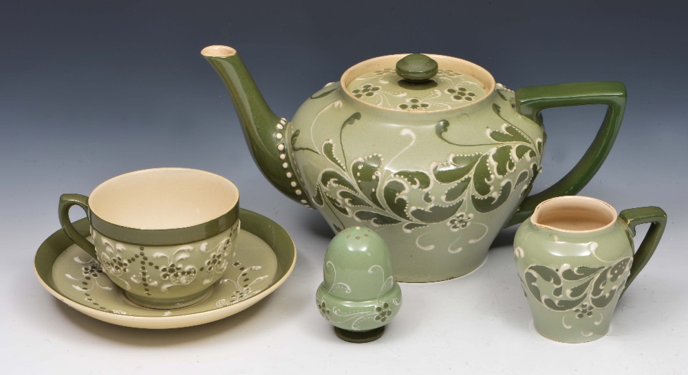 Attributed to Harold Barnard Teapot, milk jug, cup and saucer and salt, made for James Macintyre &