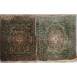 A PAIR OF TABRIZ APPLE GREEN AND APRICOT GROUND RUGS with central red flower head medallion in a