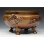 AN ORIENTAL BRONZE JARDINIERE decorated with dragon and phoenix handles on splay feet, circa 1900,