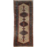 A HAMADAN RUNNER decorated with three interlinked medallions within a triple border, 284 x 81cm