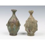 A NEAR PAIR OF KHORASSAN BRASS PERFUME BOTTLES each decorated with stylistic raised teardrop