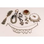 A COLLECTION OF INDIAN SILVER COLOURED METAL JEWELLERY TO INCLUDE six pendants, a seal, a necklace