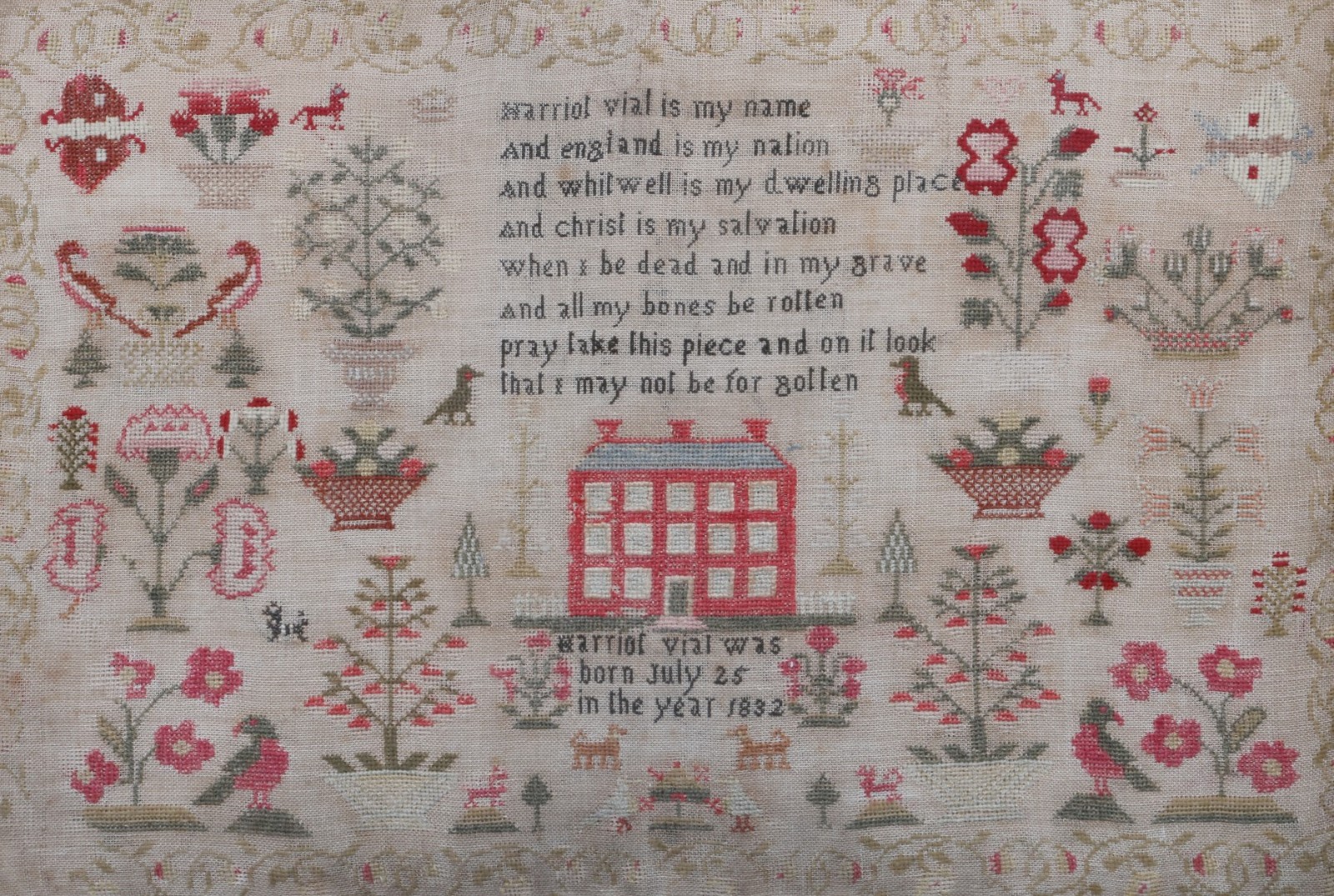 A LARGE NEEDLEWORK SAMPLER with a design of a central country house in a field of birds and trees