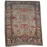 AN ANTIQUE PERSIAN ISPHAHAN CREAM GROUND RUG with three central blue and red medallions within a