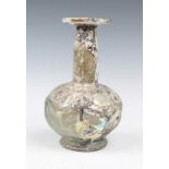 AN EARLY PERSIAN MOULDED AND FACETED ISLAMIC GLASS FLASK of baluster form with fine iridescence,
