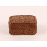 A LATE 18TH CENTURY CARVED ORANGE WOOD BOX AND COVER with stylised figure and scroll decoration