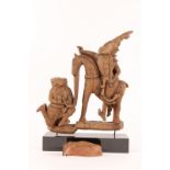 AN OLD SOUTH EAST ASIAN CARVED WOODEN GROUP of two figures and horse, 37cm high excluding base