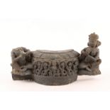AN ANTIQUE INDIAN CARVED STONE FRAGMENT decorated with dancing mermaid like figures with a seated