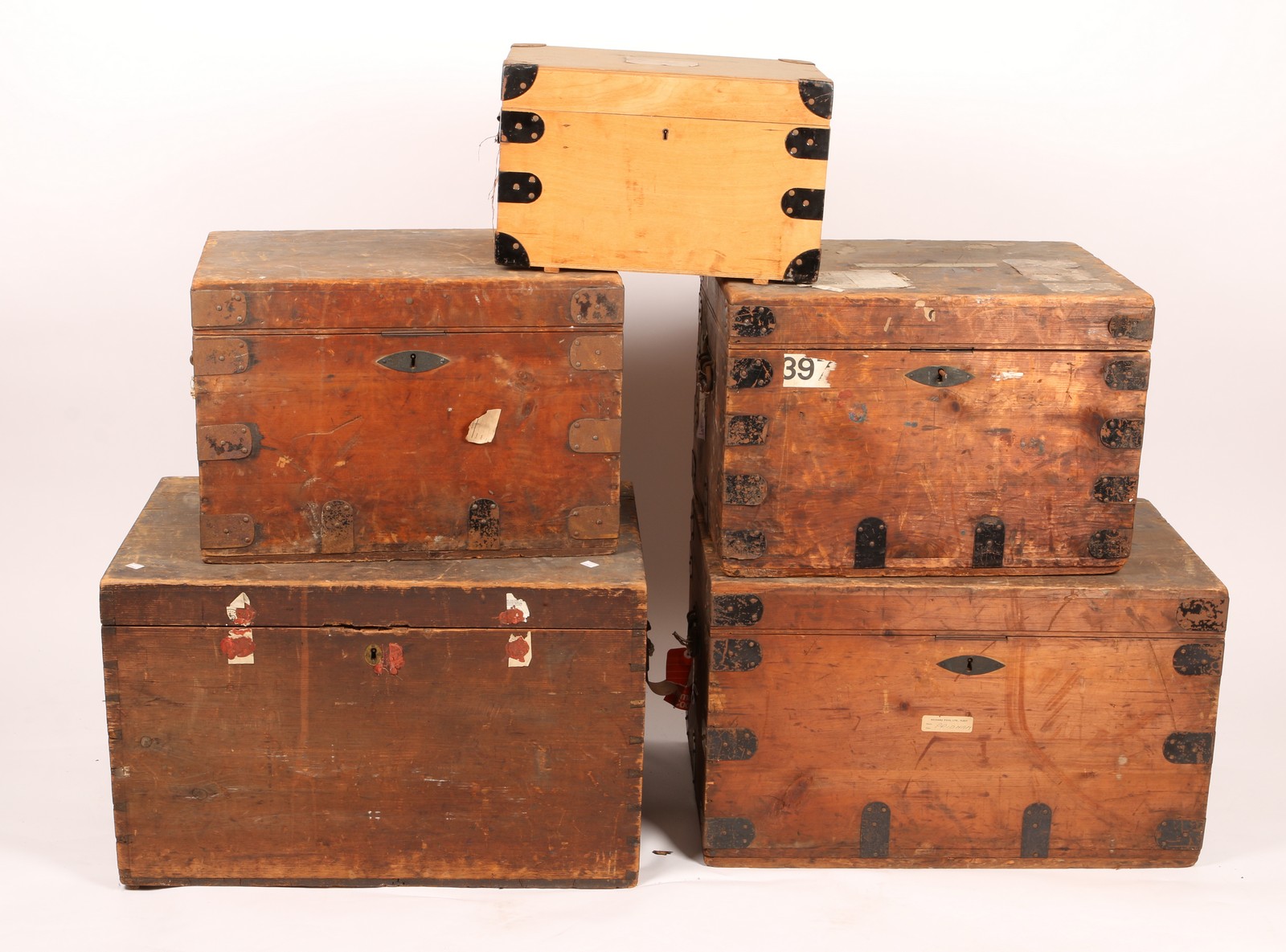 THREE METAL BOUND PINE TRAVELLING TRUNKS with lined interiors by Jeffcoat Brothers, two so labelled,