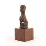 A CURIOUS CARVED WOODEN FIGURE of a half man half animal seated astride another animal, perhaps