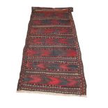 A BELOUCH DARK RED GROUND FLAT WEAVE RUNNER with banded stylised decoration, 293 x 74cm