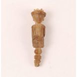 AN OLD SOUTH EAST ASIAN CARVED HORN CHARM FIGURE in the form of a crowned man