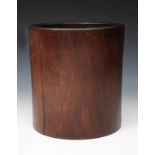 A CHINESE HUANGHUALI WOOD CYLINDRICAL BRUSH POT of plain form, 20.5cm high x 19cm diameter