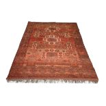 AN AFGHAN WINE GROUND RUG with stylised geometric designs within a wide border, 219 x 148cm