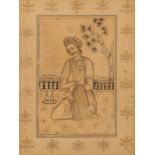 AN 18TH CENTURY PERSIAN DRAWING of a man seated on a terrace drinking wine within a foliate