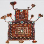 AN AFSHAR SALT BAG with polychrome decoration, attached tassels and beads, approximately 54 x 40cm