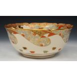 A JAPANESE SATSUMA EARTHENWARE BOWL with petal edge, with gilded figure and floral decoration,
