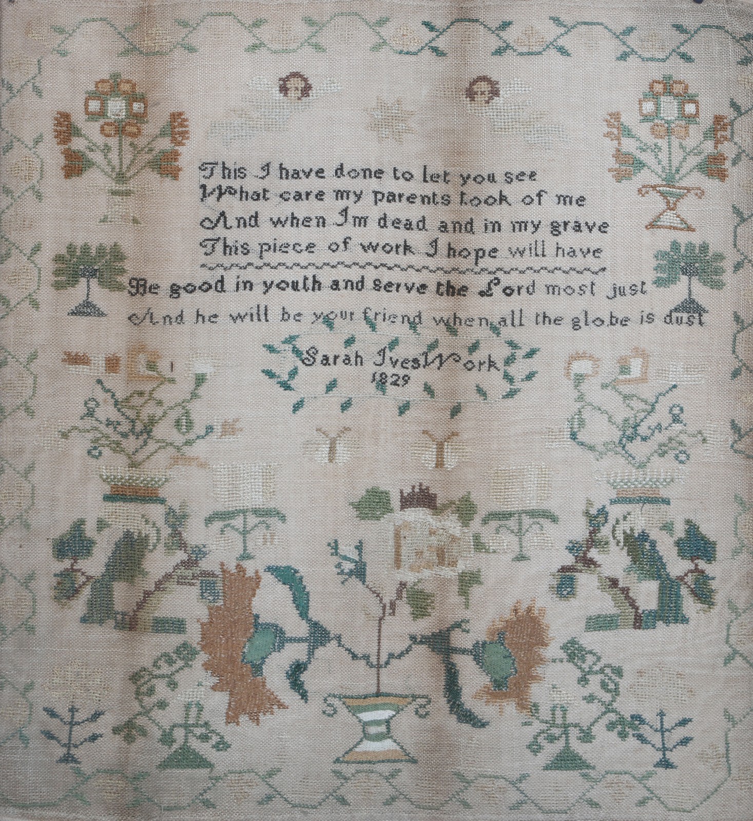 A CHILD'S NEEDLEWORK SAMPLER by Sarah Ives 1829 with poem angel and foliate decoration in wooden