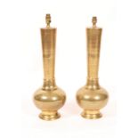 A PAIR OF MIDDLE EASTERN BRASS TABLE LAMPS of baluster form with engraved decoration, 54cm high (2)